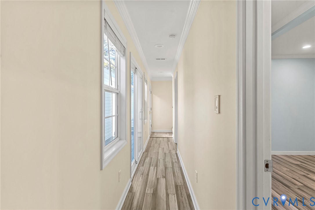 8059 Varina Road Henrico, VA 23231 - Photo 23 of 45 a view of a hallway with wooden floor and a bathroom