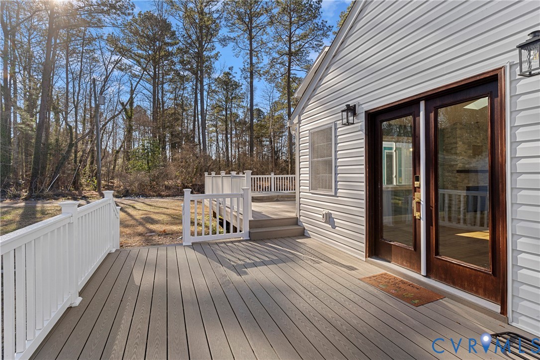 8059 Varina Road Henrico, VA 23231 - Photo 31 of 45 a view of deck with table and chairs and wooden floor
