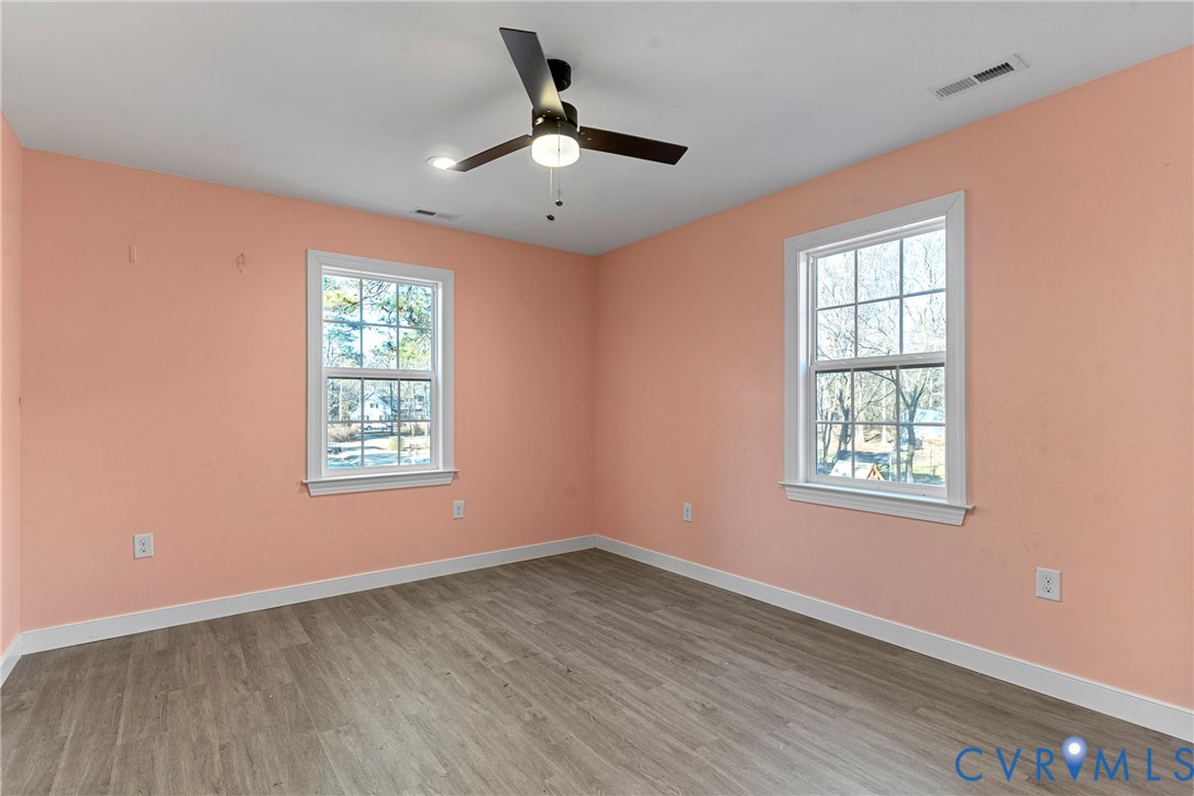 8059 Varina Road Henrico, VA 23231 - Photo 45 of 45 a view of an empty room with wooden floor and a window