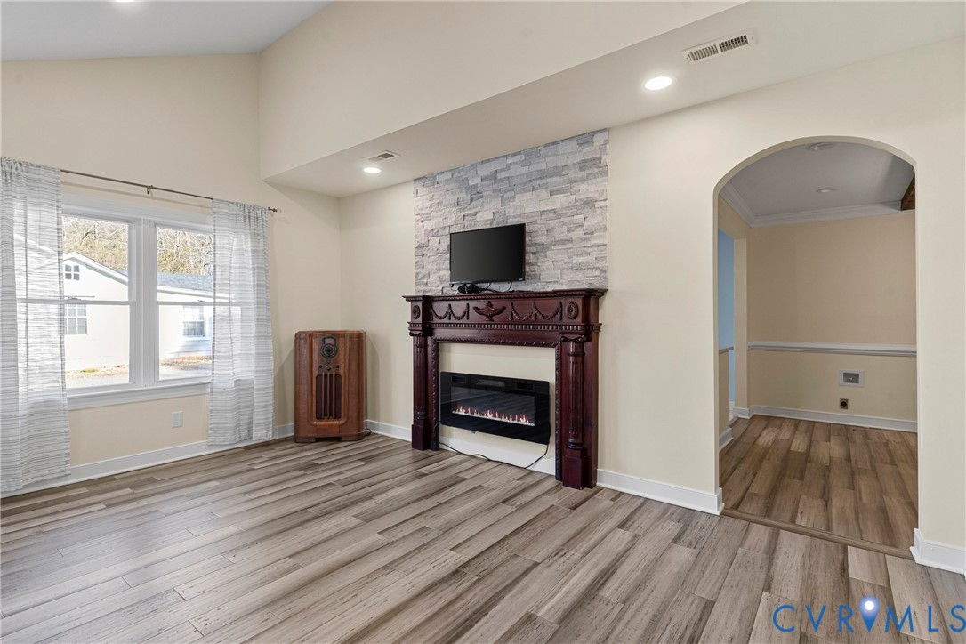 8059 Varina Road Henrico, VA 23231 - Photo 5 of 45 an empty room with wooden floor fireplace and windows