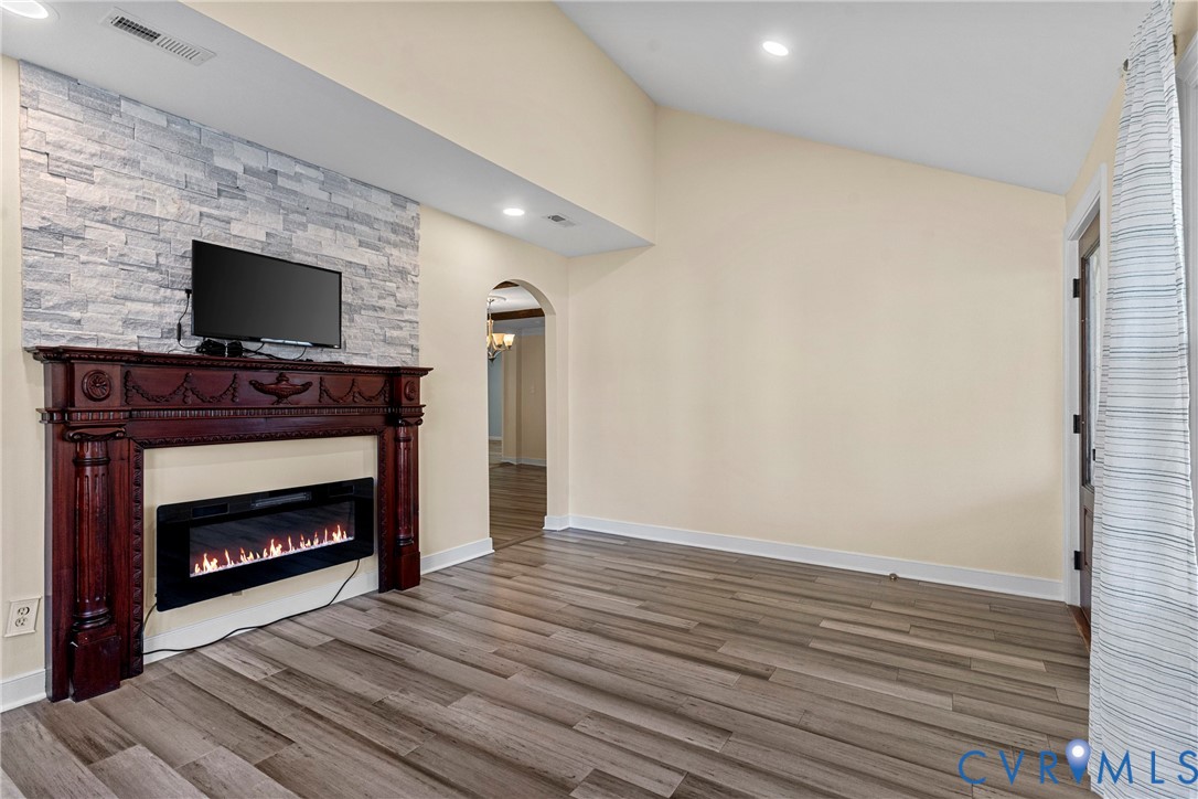 8059 Varina Road Henrico, VA 23231 - Photo 6 of 45 a view of an empty room with wooden floor fireplace and a window