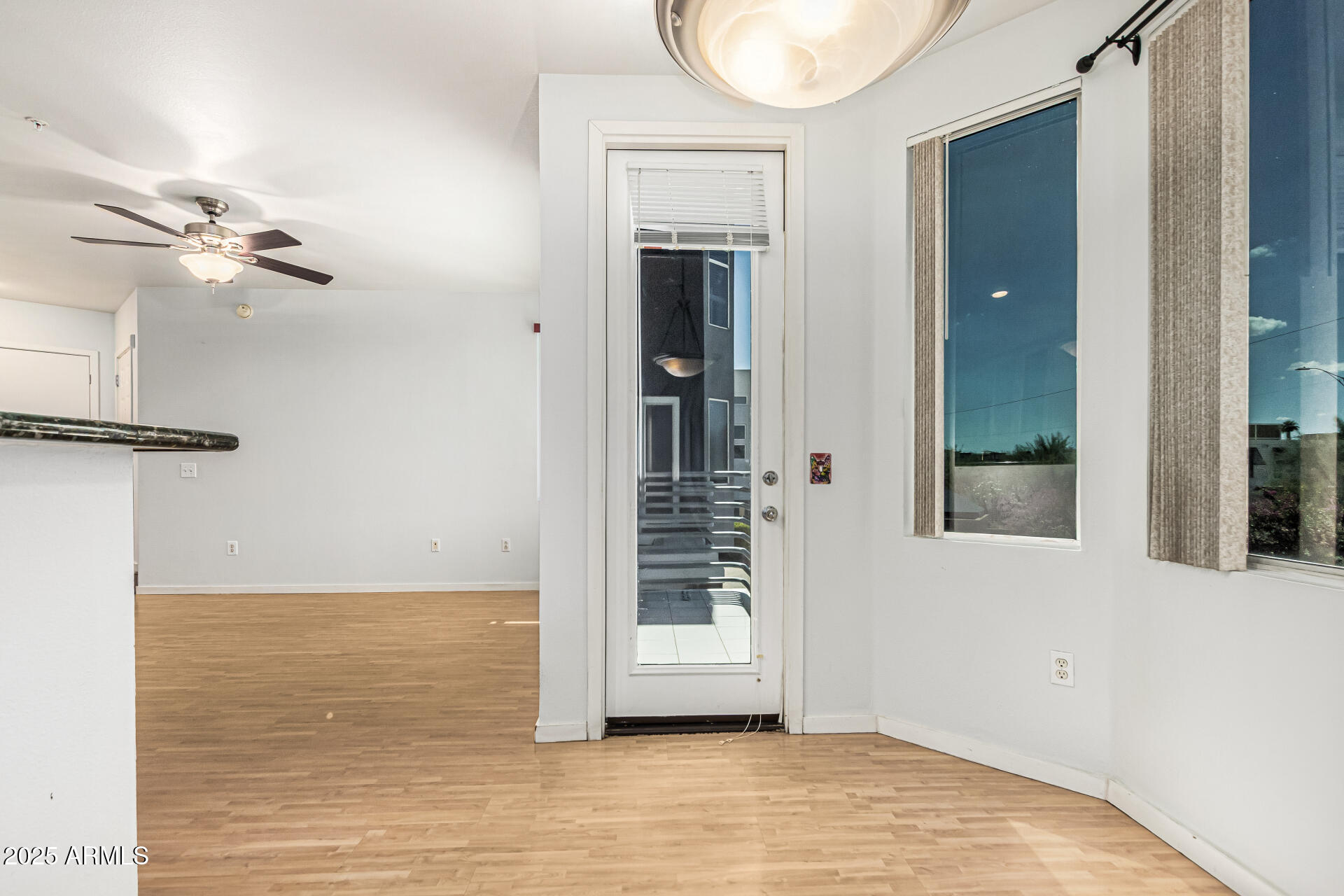 3633 North 3rd Avenue, Unit 2083 Phoenix, AZ 85013 - Photo 15 of 54 a view of a room with wooden floor and ceiling fan