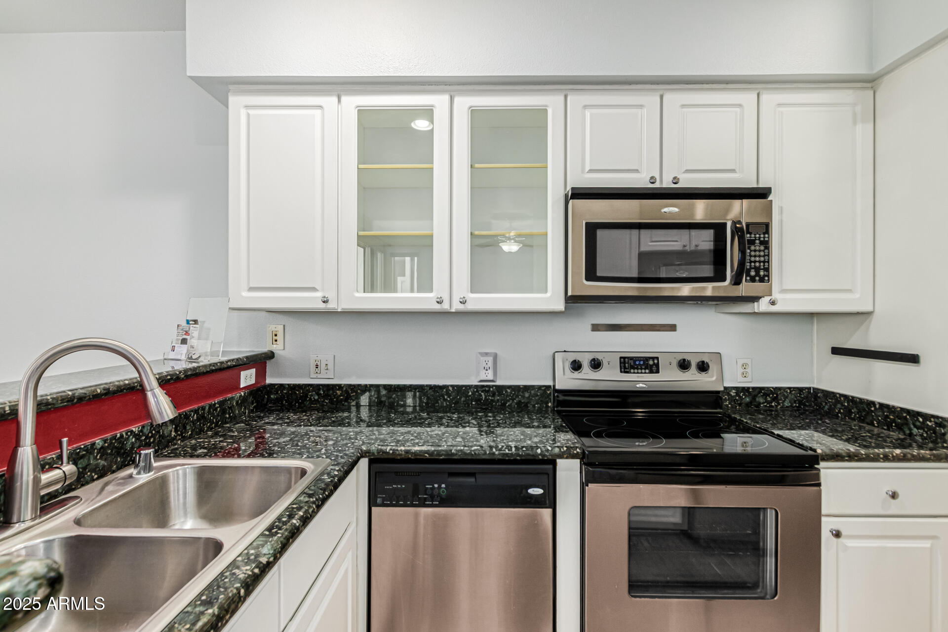 3633 North 3rd Avenue, Unit 2083 Phoenix, AZ 85013 - Photo 18 of 54 a kitchen with stainless steel appliances granite countertop a sink stove and microwave