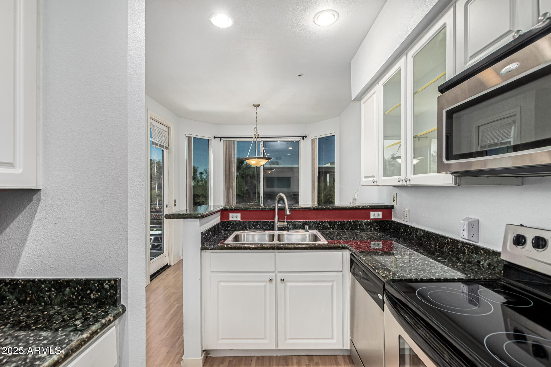 3633 North 3rd Avenue, Unit 2083 Phoenix, AZ 85013 - Photo 20 of 54 a kitchen with stainless steel appliances granite countertop a sink stove and cabinets