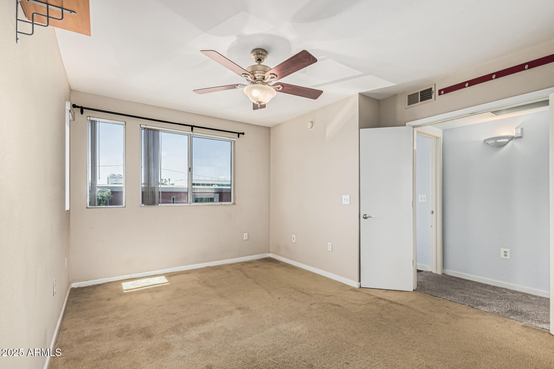3633 North 3rd Avenue, Unit 2083 Phoenix, AZ 85013 - Photo 25 of 54 a view of an empty room with chandelier fan and fire place