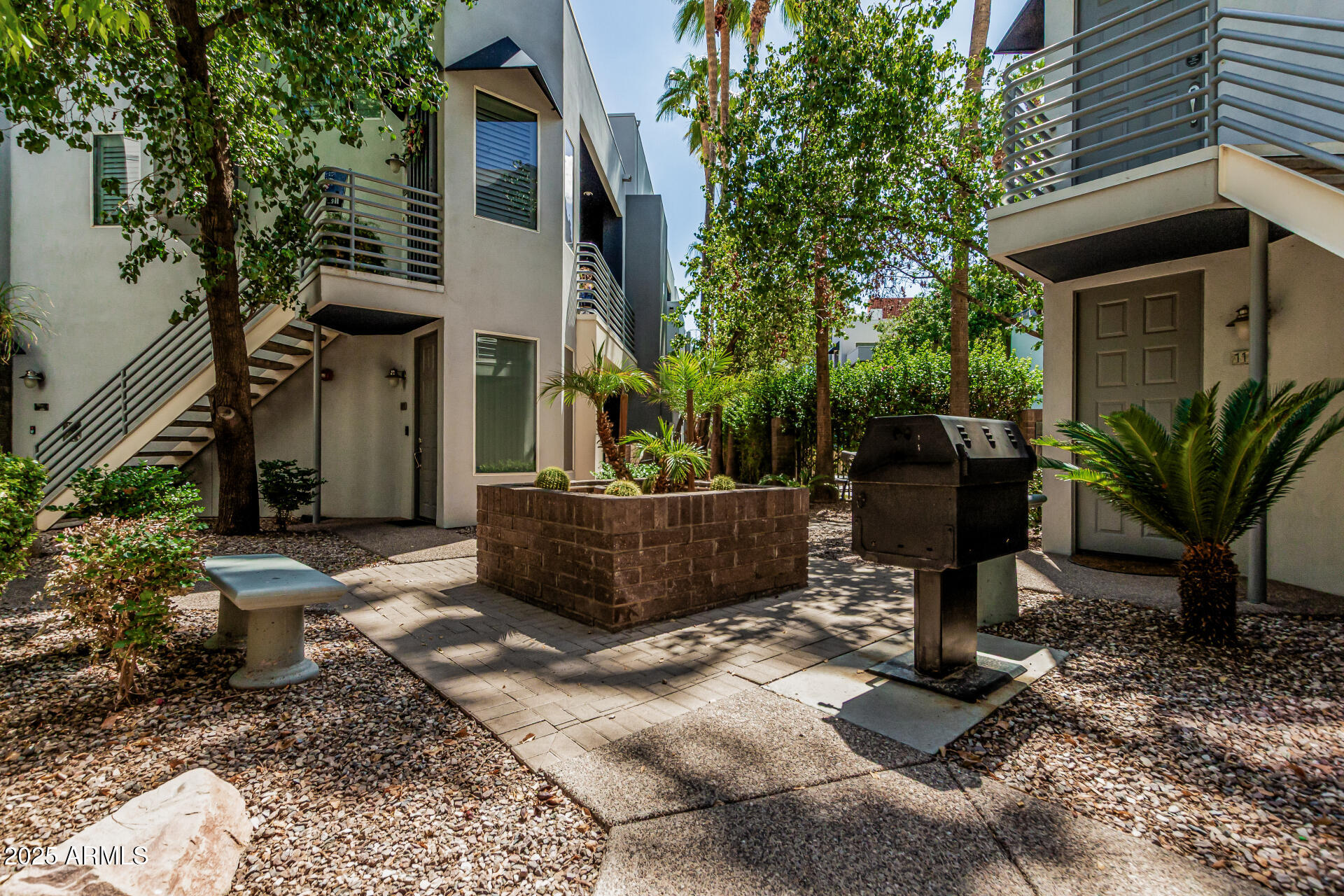 3633 North 3rd Avenue, Unit 2083 Phoenix, AZ 85013 - Photo 52 of 54 a view of a chairs and table in the backyard