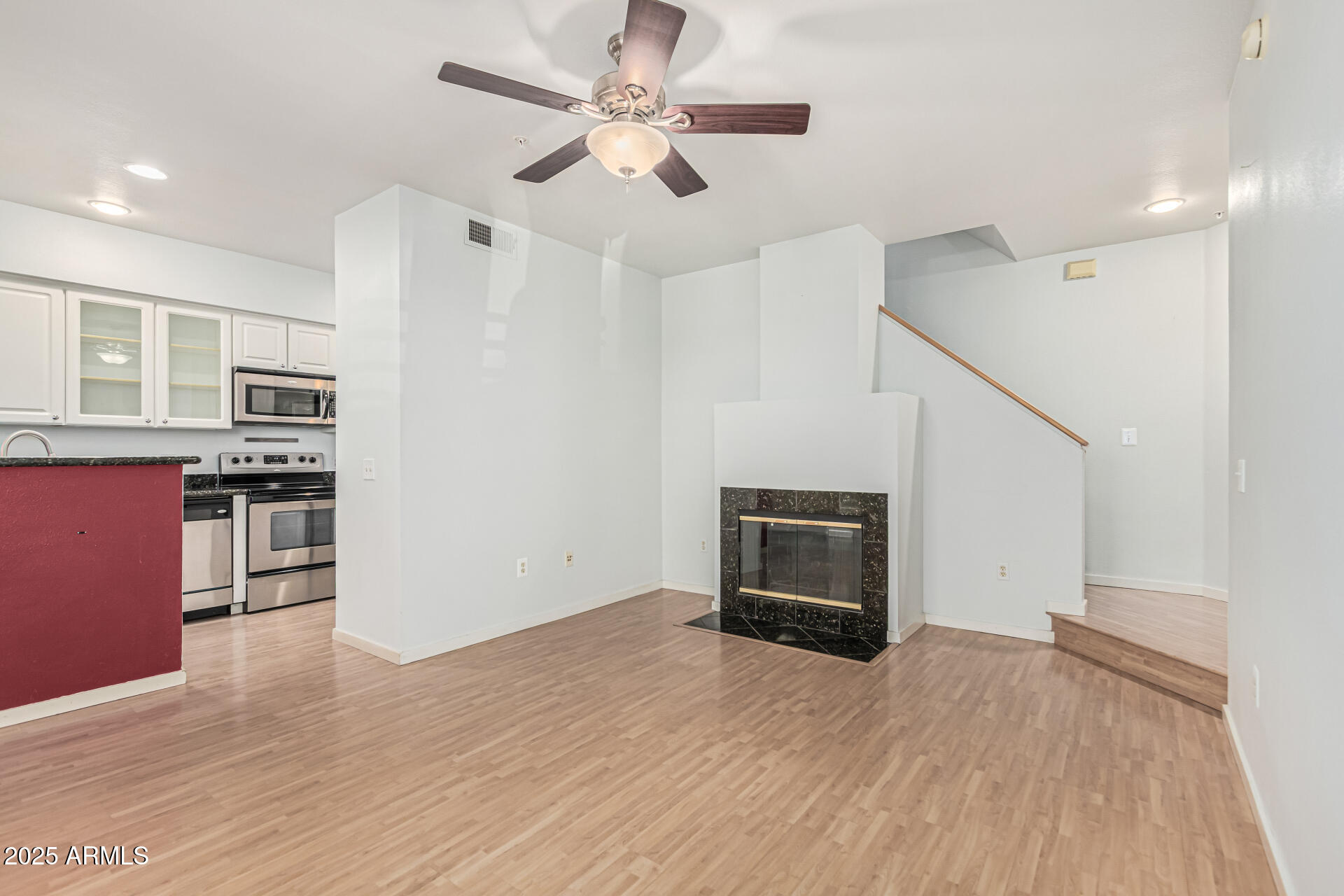 3633 North 3rd Avenue, Unit 2083 Phoenix, AZ 85013 - Photo 9 of 54 a view of a livingroom with wooden floor and a ceiling fan