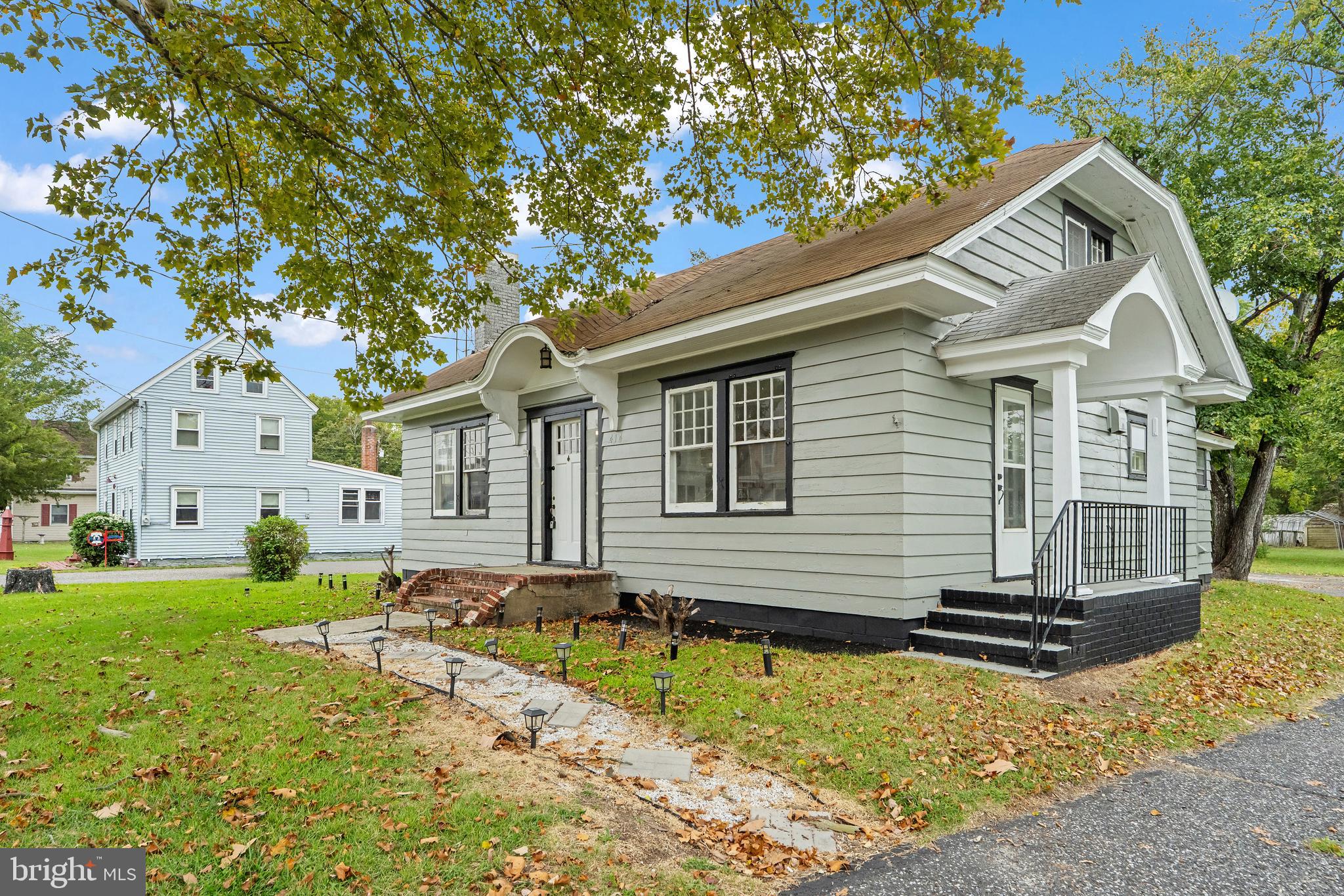 414 Main Street Dorchester, NJ 08316 - Photo 1 of 22 a front view of a house with a yard