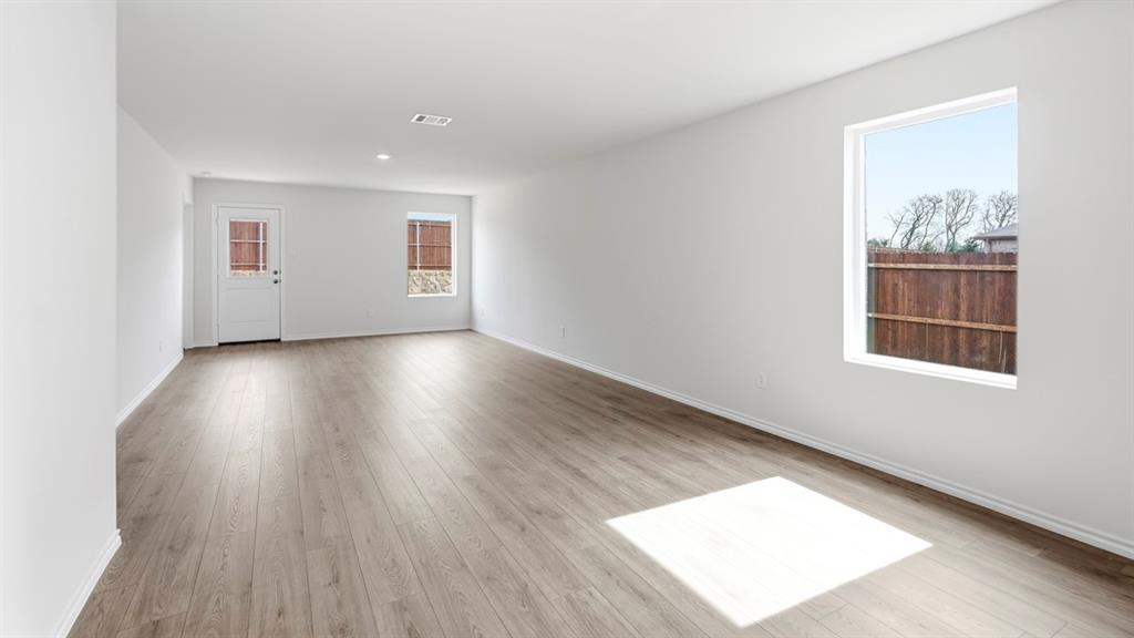 3519 Spring Time Street Forney, TX 75126 - Photo 30 of 37 Spacious interior featuring wood-finish flooring, white walls, and multiple windows