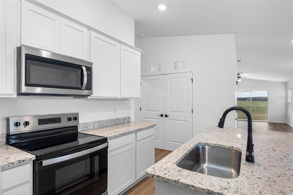Undisclosed Address Lakeland, FL 33809 - Photo 3 of 7 a kitchen with a sink and stainless steel appliances