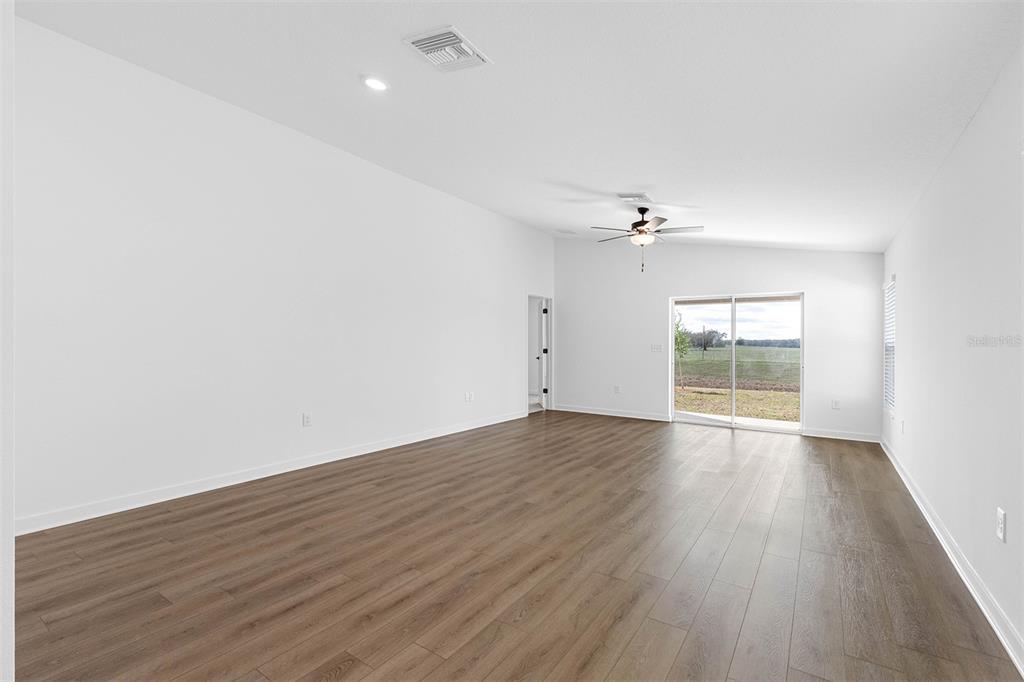 Undisclosed Address Lakeland, FL 33809 - Photo 5 of 7 wooden floor in an empty room with a window