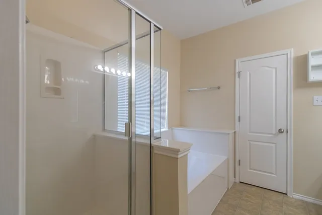 a bathroom with a shower and a sink