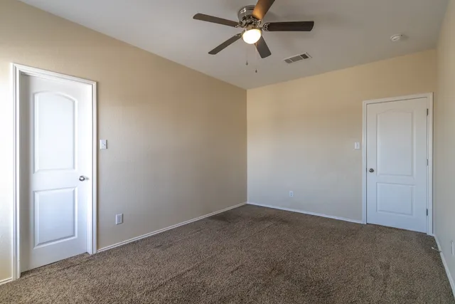 a view of a big room with a chandelier fan