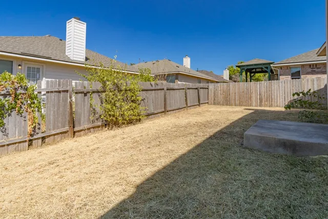 a big house with a large tree in front of it
