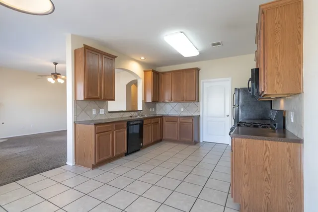a kitchen with stainless steel appliances granite countertop a sink and cabinets