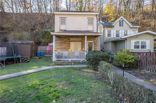 a view of backyard of house with green space