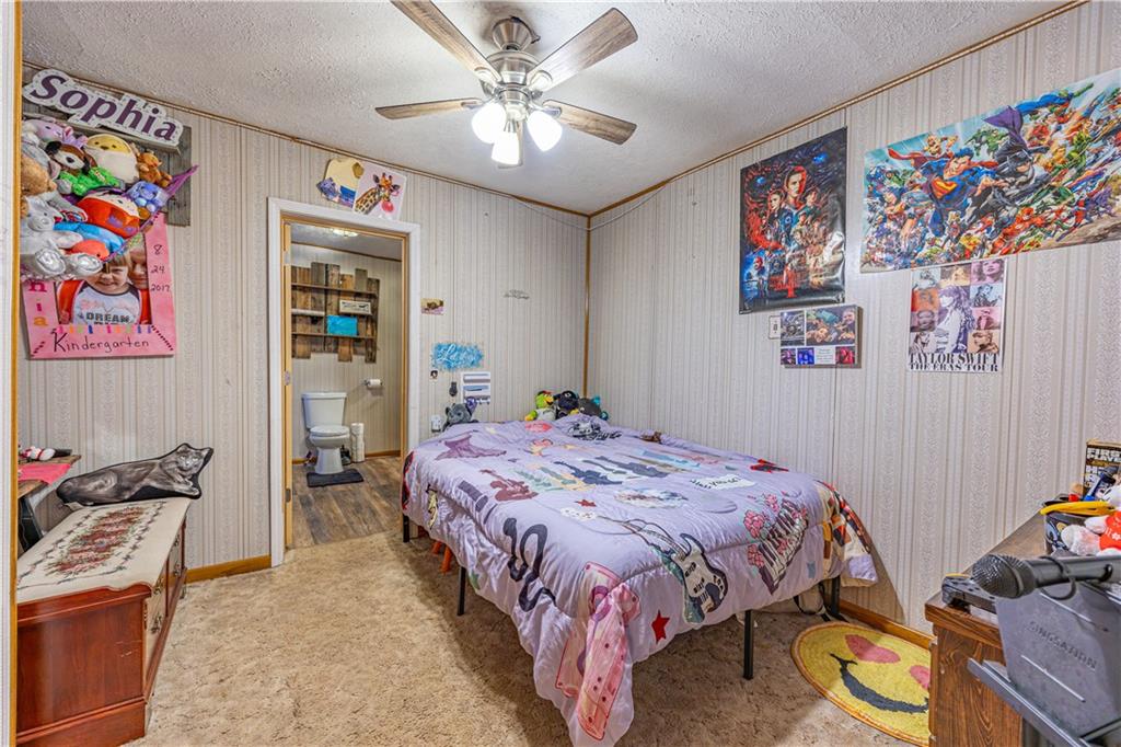 3318 Spring Garden Road Pittsburgh, PA 15212 - Photo 11 of 22 a bedroom with a bed a wall painting and a desk