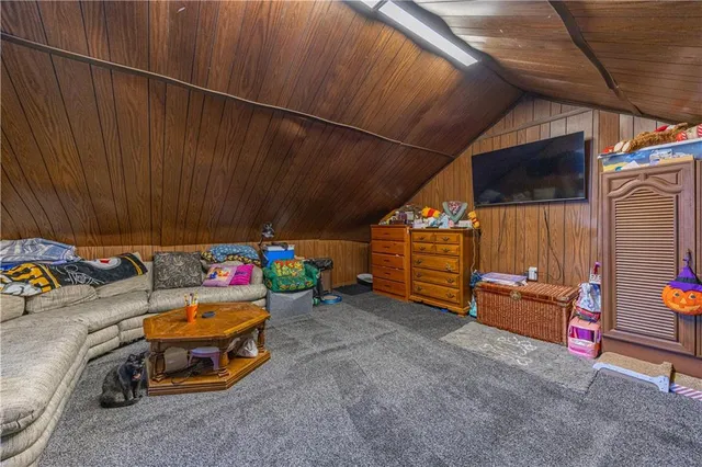 a room with wooden cabinets and stainless steel appliances