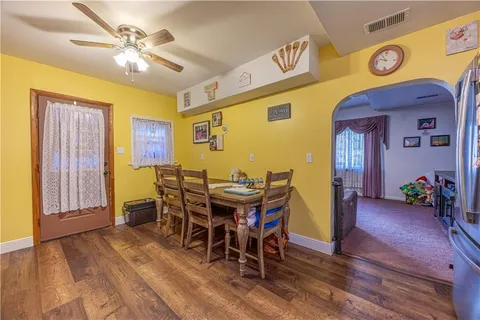 a view of a dining room with furniture and chandelier