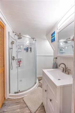 a bathroom with a sink mirror and a shower