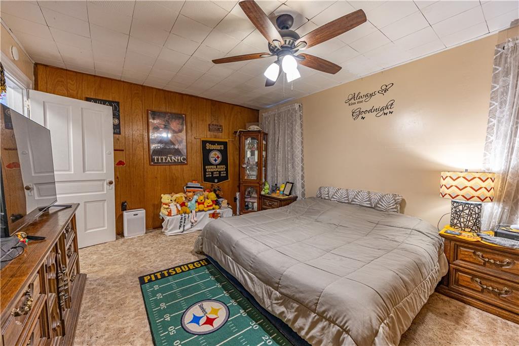 3318 Spring Garden Road Pittsburgh, PA 15212 - Photo 9 of 22 a bedroom with a bed a table and chair