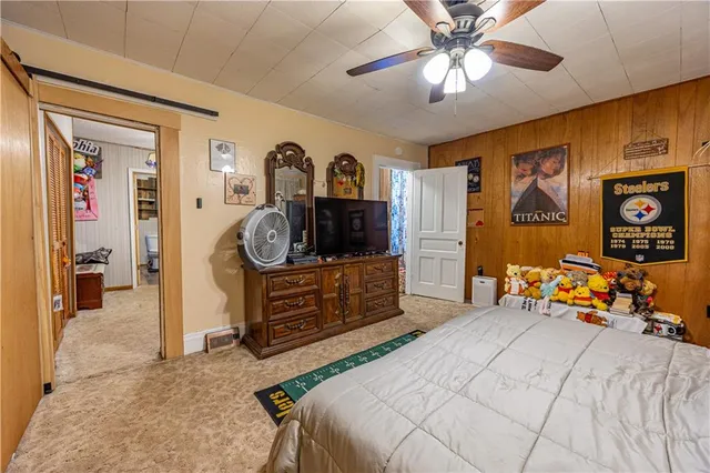 a bedroom with furniture and a mirror