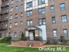 37 Brompton Road, Unit 1D Great Neck, NY 11021 - Photo 1 of 1 a front view of a building with garden