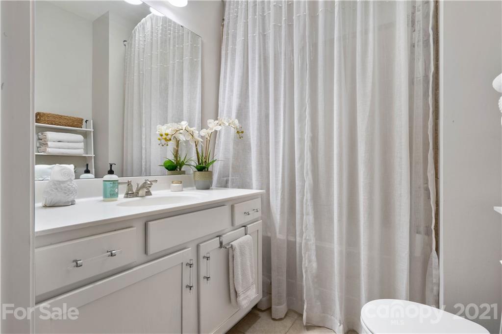 1433 Camden Road Charlotte, NC 28203 - Photo 13 of 22 a bathroom with a granite countertop sink and a mirror