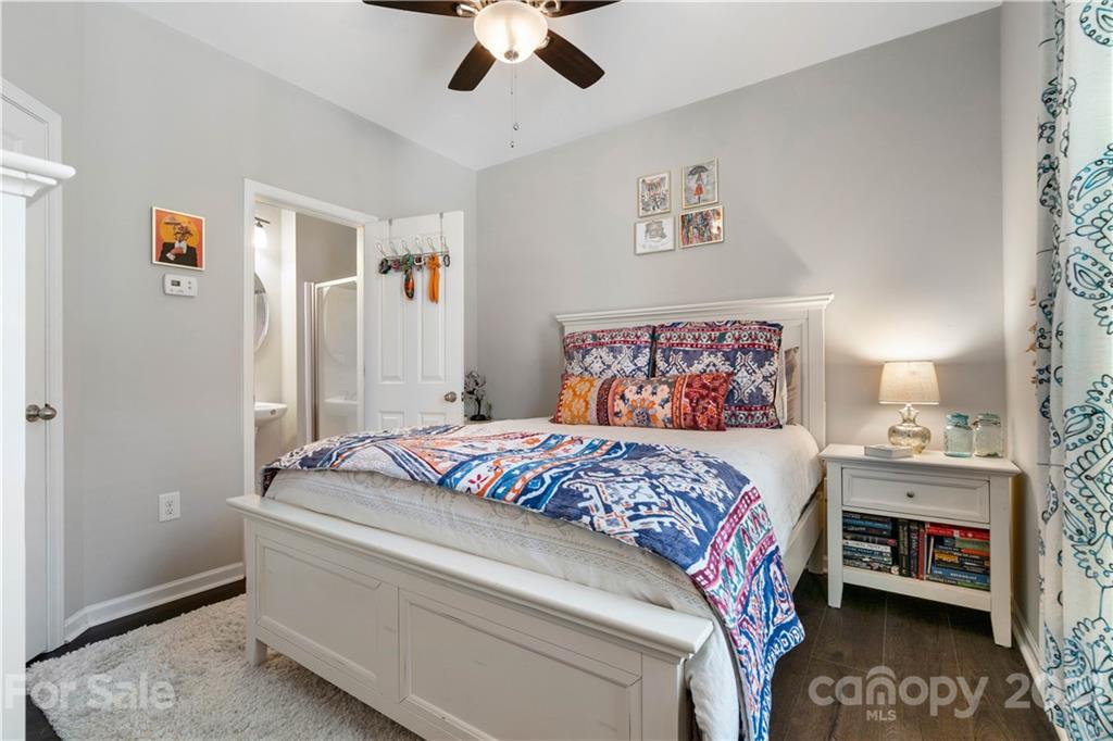 1433 Camden Road Charlotte, NC 28203 - Photo 16 of 22 a bedroom with a bed and a chandelier