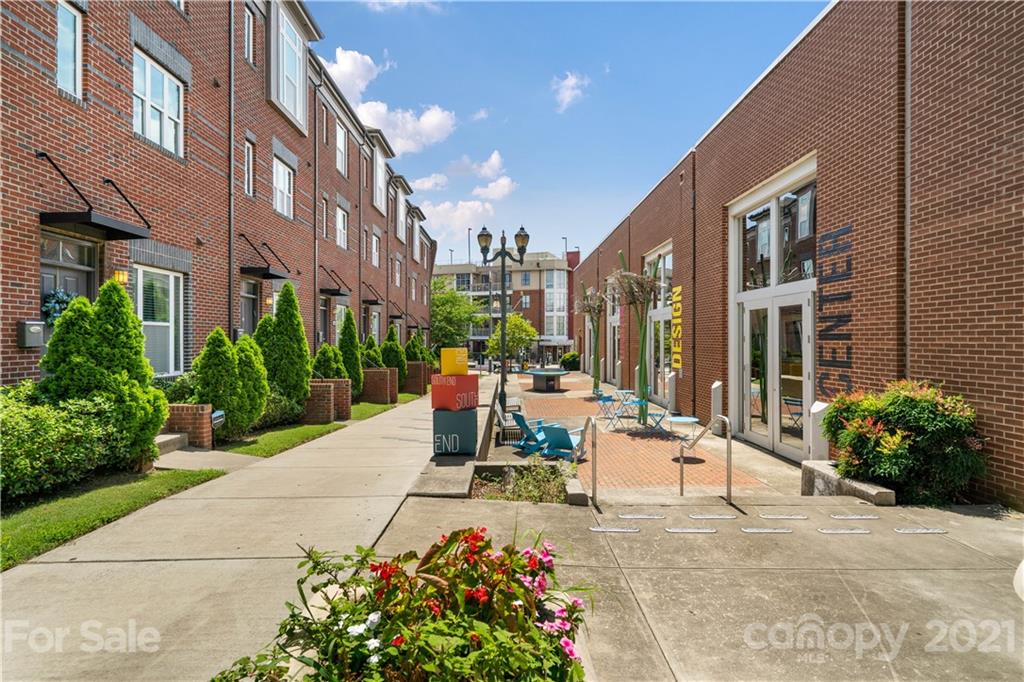 1433 Camden Road Charlotte, NC 28203 - Photo 20 of 22 a view of a patio with a table and chairs and potted plants