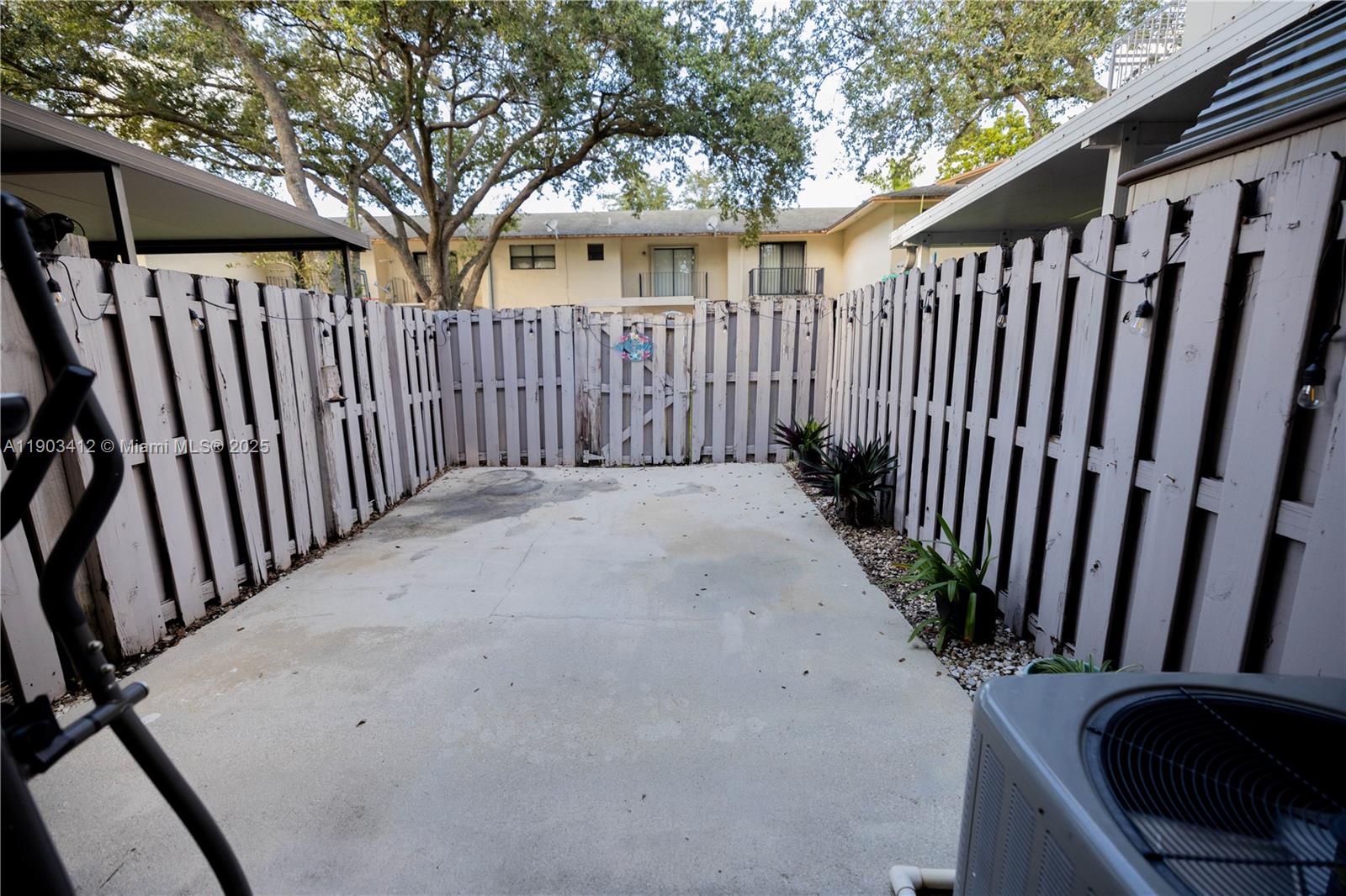 12955 Southwest 66th Lane, Unit 2092 Miami, FL 33183 - Photo 16 of 46 a view of a yard with wooden fence