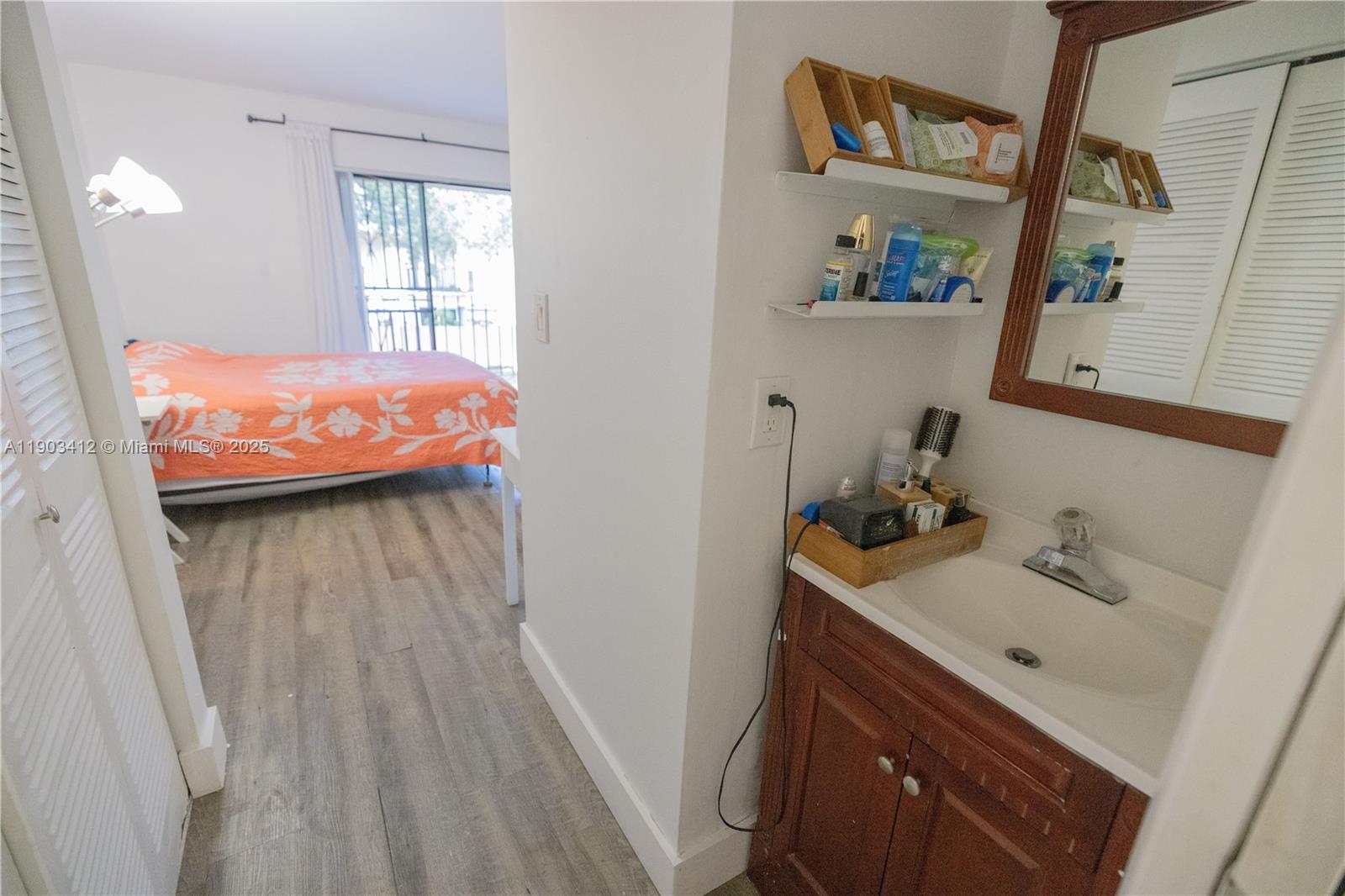 12955 Southwest 66th Lane, Unit 2092 Miami, FL 33183 - Photo 2 of 46 a bathroom with a sink and a mirror
