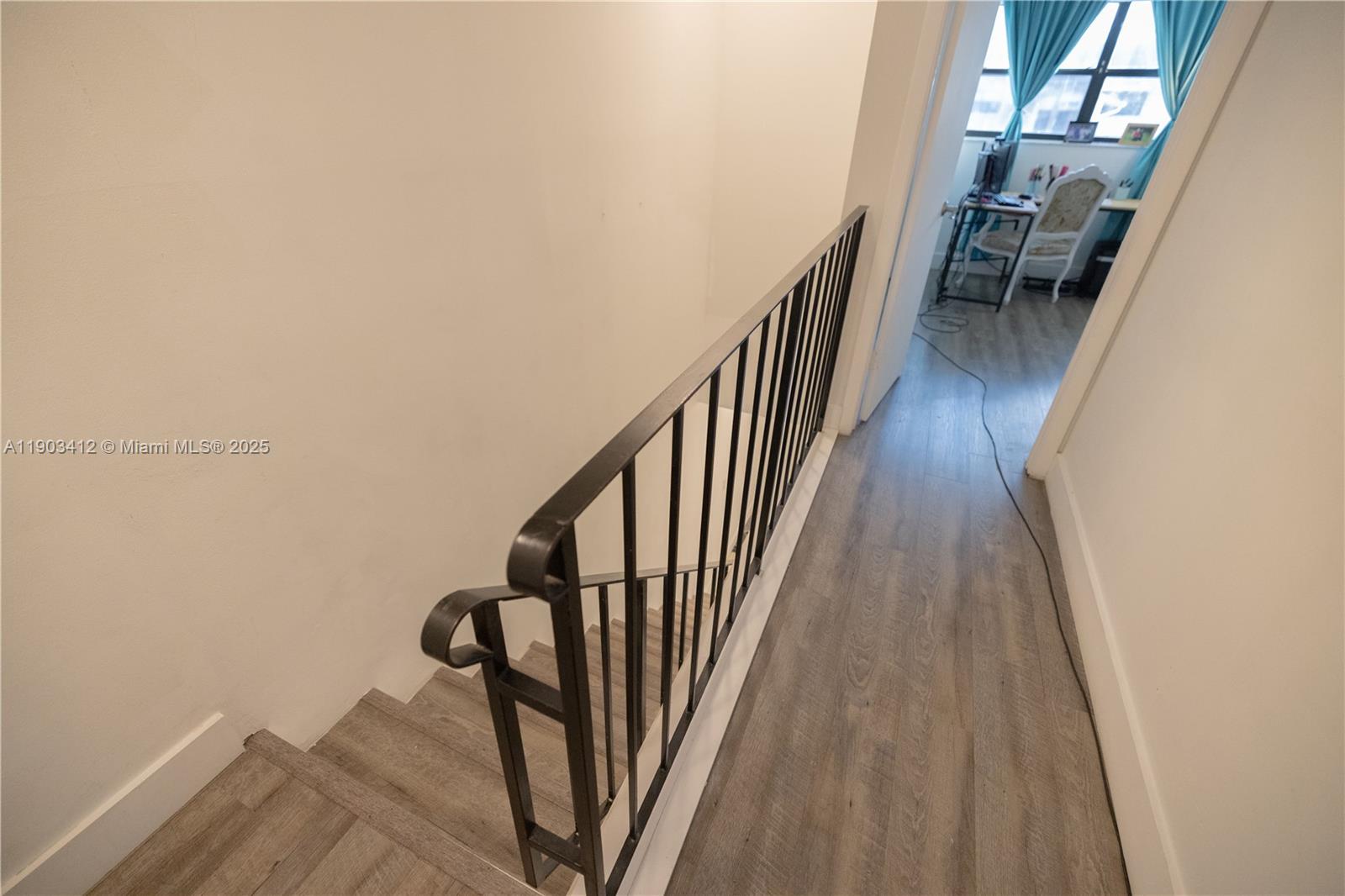 12955 Southwest 66th Lane, Unit 2092 Miami, FL 33183 - Photo 22 of 46 a view of a hallway with wooden floor and stairs