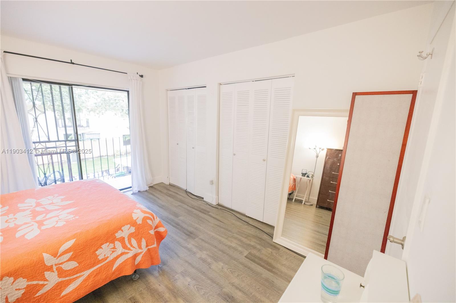 12955 Southwest 66th Lane, Unit 2092 Miami, FL 33183 - Photo 31 of 46 a bedroom with a bed and a large mirror in it