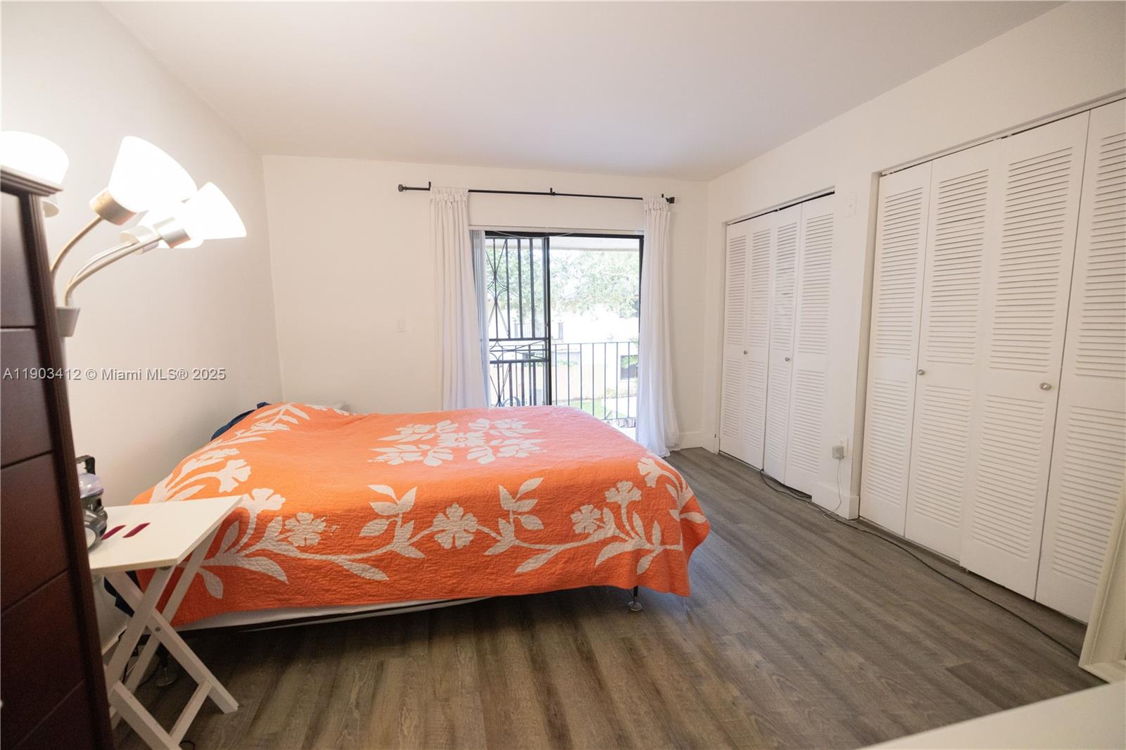 12955 Southwest 66th Lane, Unit 2092 Miami, FL 33183 - Photo 35 of 46 a bed sitting in a bedroom next to a window