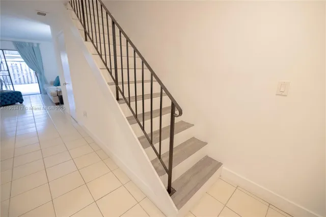 a view of a dining room with furniture and a chandelier