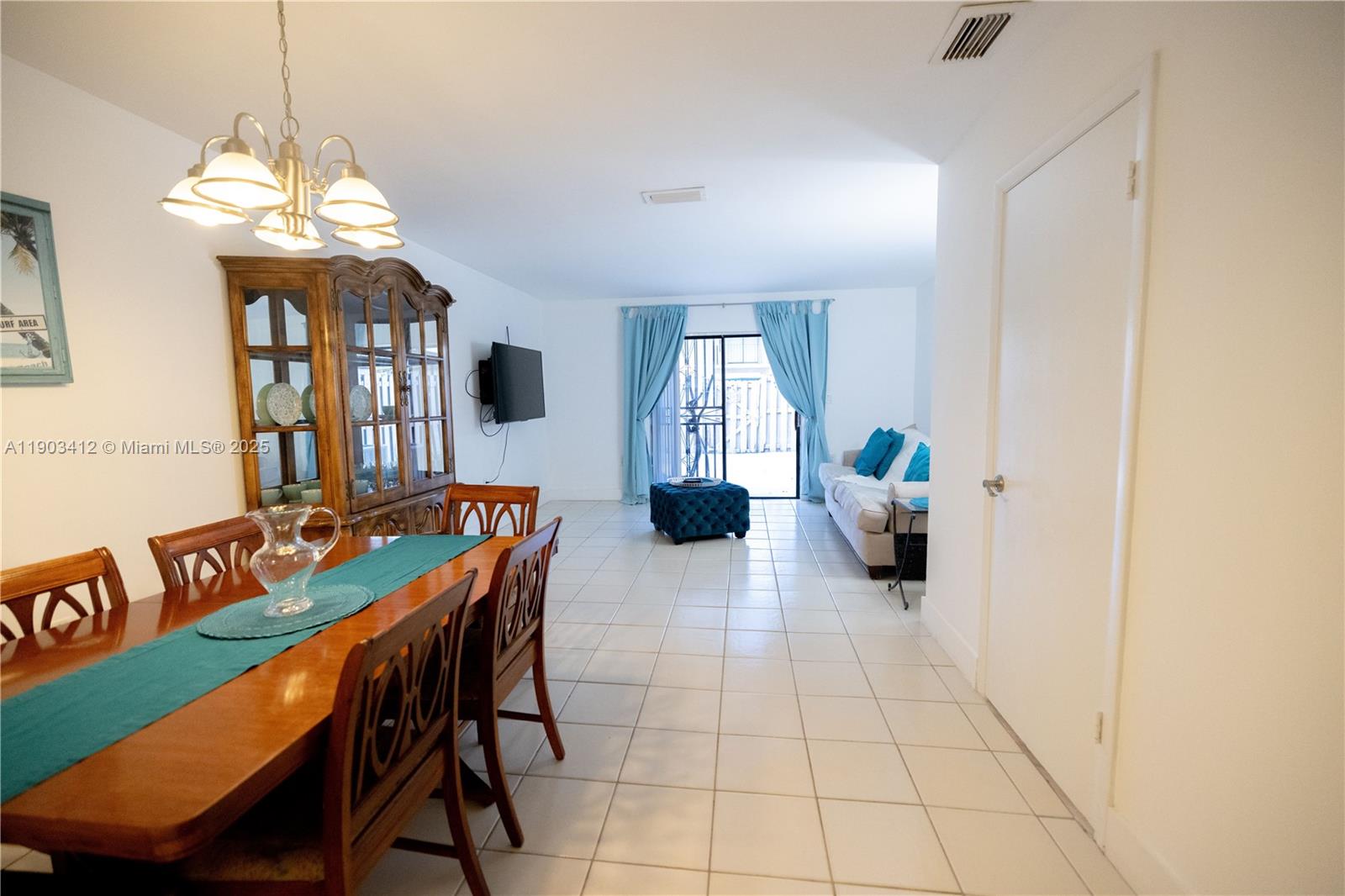 12955 Southwest 66th Lane, Unit 2092 Miami, FL 33183 - Photo 41 of 46 a view of a dining room with furniture and a chandelier