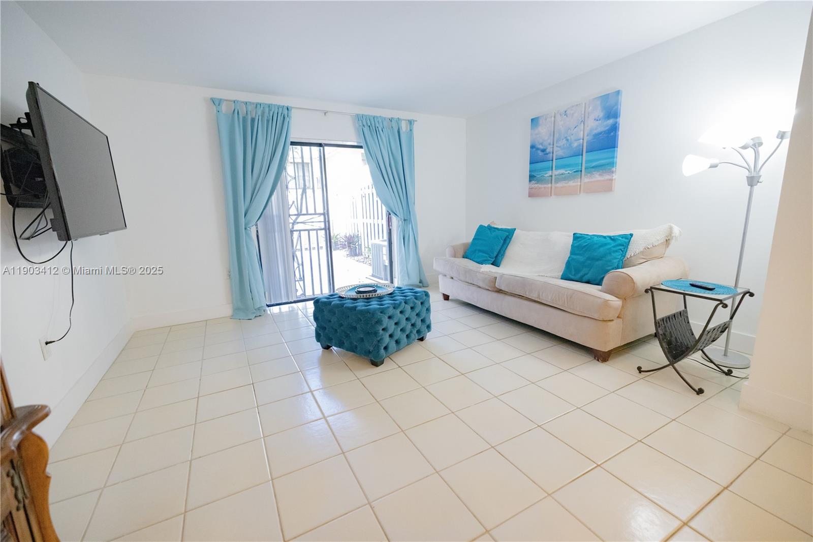 12955 Southwest 66th Lane, Unit 2092 Miami, FL 33183 - Photo 45 of 46 a living room with furniture and a flat screen tv