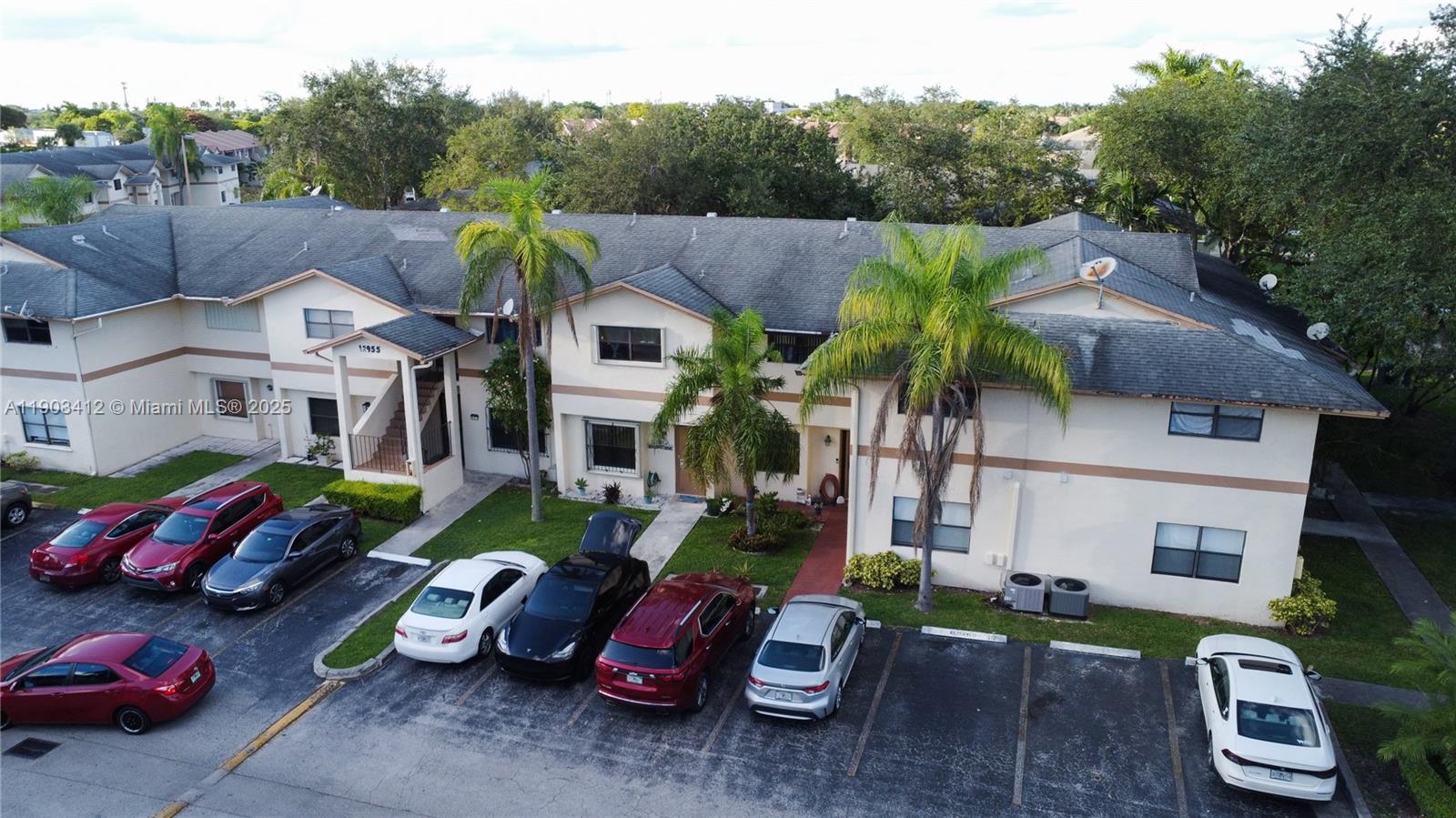 12955 Southwest 66th Lane, Unit 2092 Miami, FL 33183 - Photo 9 of 46 a front view of a house with garden