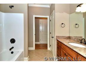 230 Porters Ridge Canton, NC 28716 - Photo 11 of 21 a bathroom with a granite countertop sink a mirror and shower