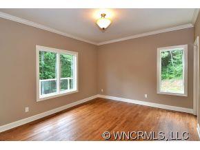 230 Porters Ridge Canton, NC 28716 - Photo 7 of 21 an empty room with wooden floor and a window