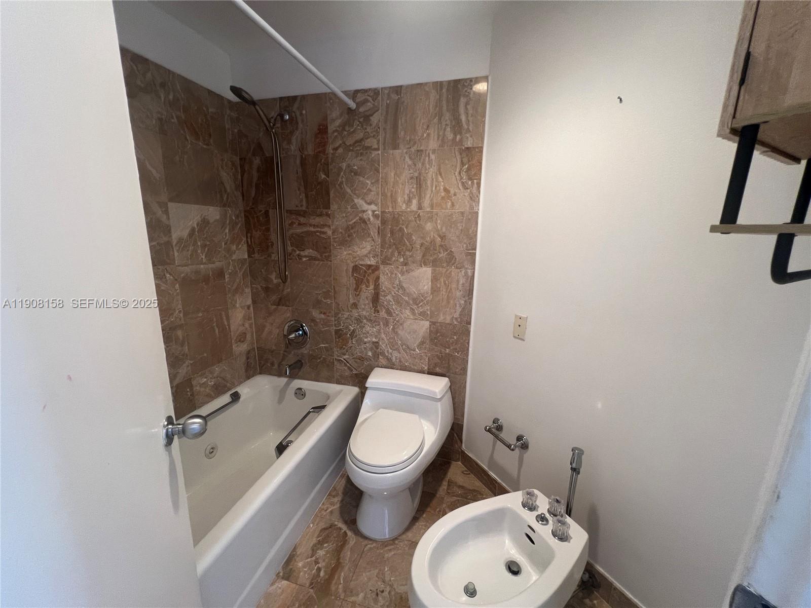 888 Brickell Key Drive, Unit 806 Miami, FL 33131 - Photo 12 of 20 a bathroom with a toilet and a shower