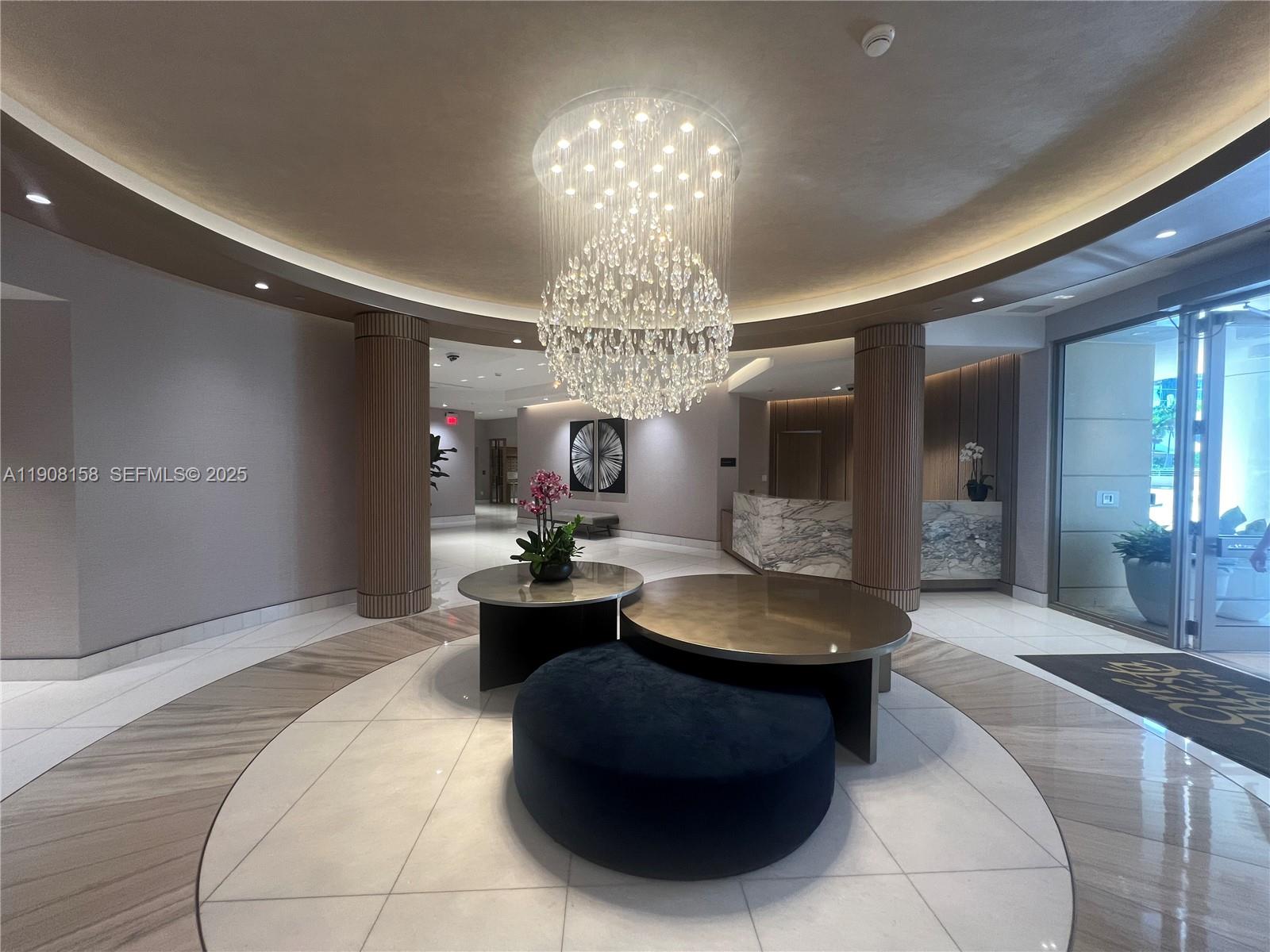 888 Brickell Key Drive, Unit 806 Miami, FL 33131 - Photo 17 of 20 a living room with fireplace furniture and a chandelier