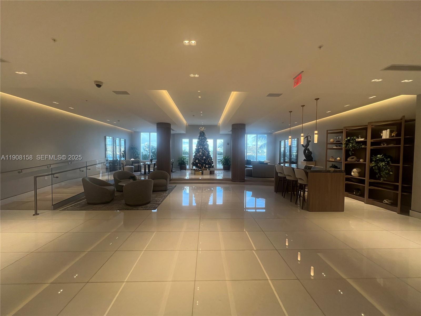888 Brickell Key Drive, Unit 806 Miami, FL 33131 - Photo 18 of 20 a lobby with a table and chairs