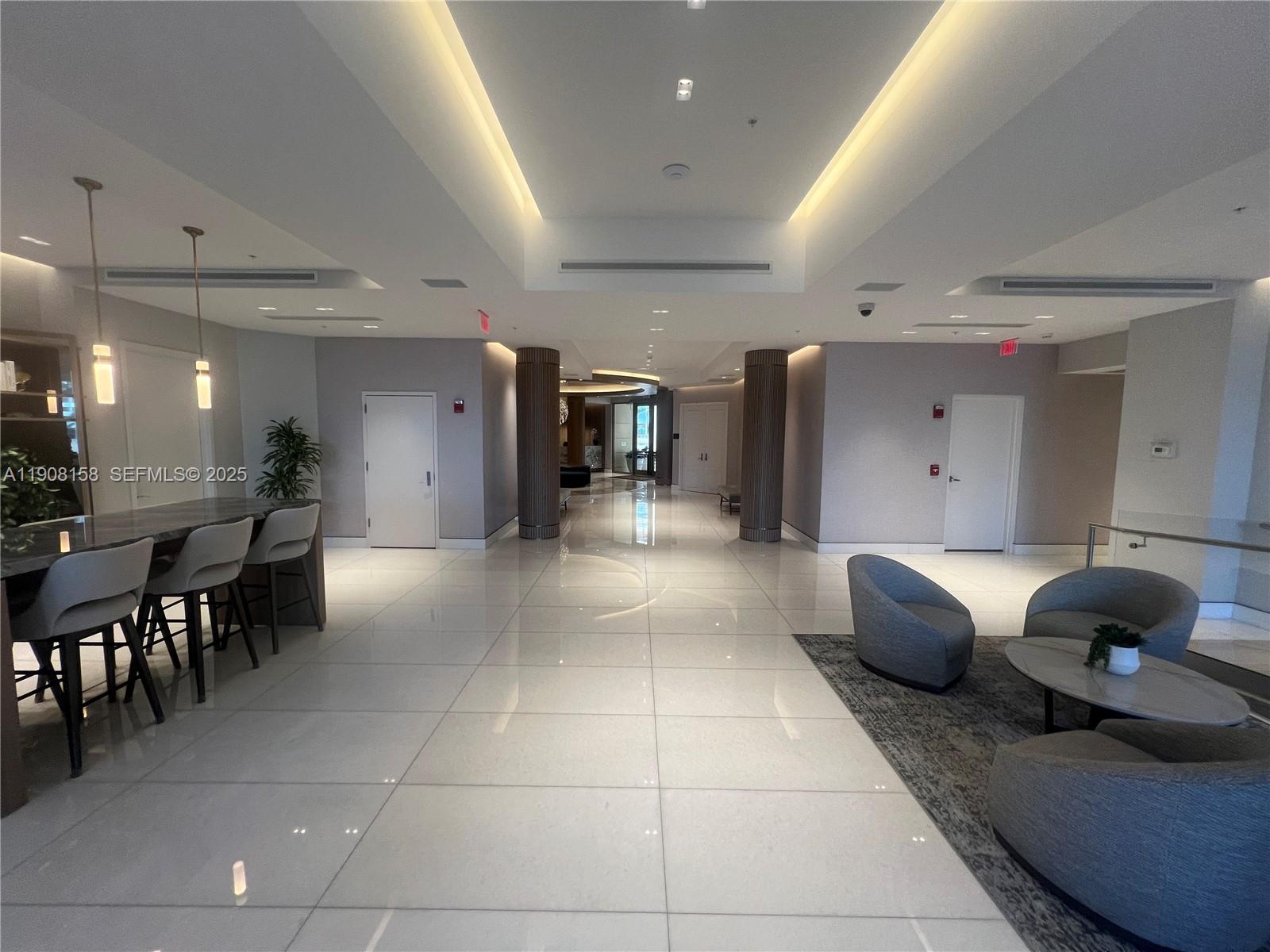 888 Brickell Key Drive, Unit 806 Miami, FL 33131 - Photo 19 of 20 a living room with furniture and dining table