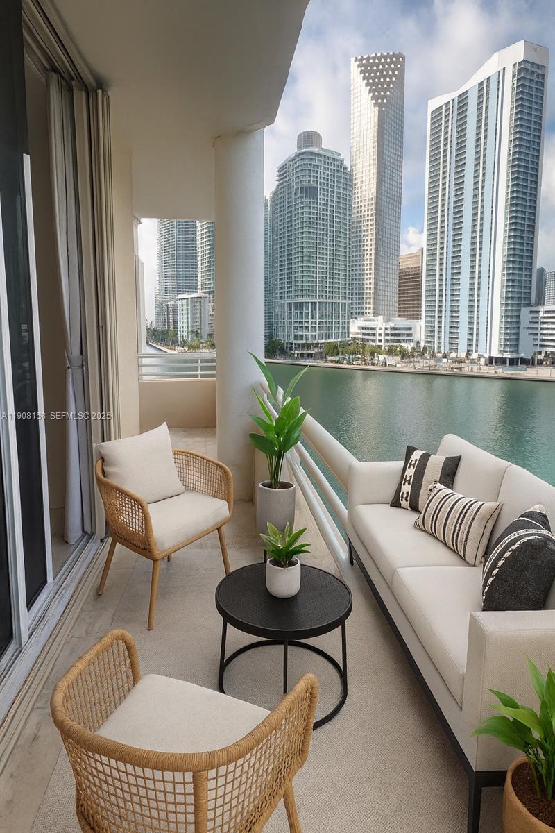 888 Brickell Key Drive, Unit 806 Miami, FL 33131 - Photo 2 of 20 a living room with furniture and floor to ceiling windows