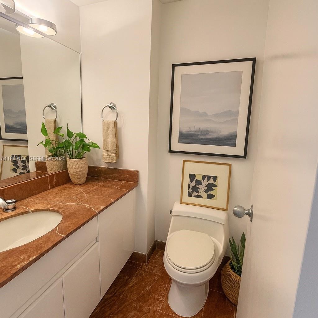 888 Brickell Key Drive, Unit 806 Miami, FL 33131 - Photo 7 of 20 a bathroom with a toilet a sink and mirror