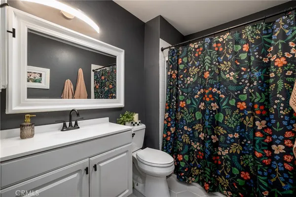 a bathroom with a sink toilet and mirror