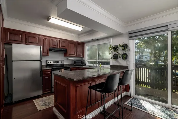 a kitchen with kitchen island a counter top space a sink appliances and cabinets