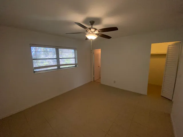 a view of a livingroom with a ceiling fan and window